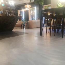ClaudiCemento microcement on the floors installed by SOBO. Commercial - restaurant